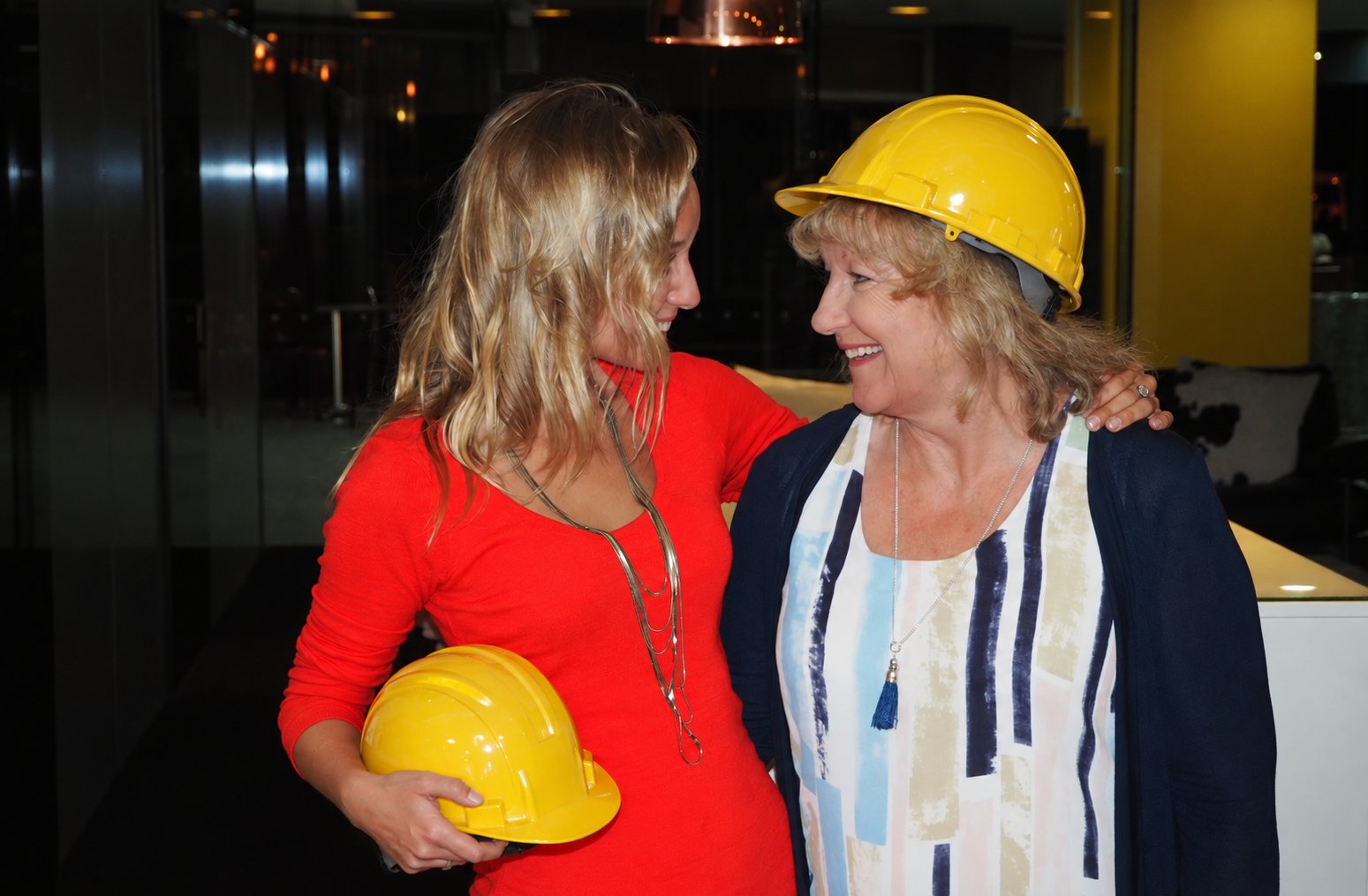 Jacki and Deb, the mother-daughter team behind Hard Hat Hampers, sharing a hard hat